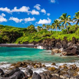 a rocky beach next to a body of water