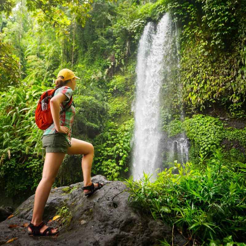 a person standing next to a waterfall
