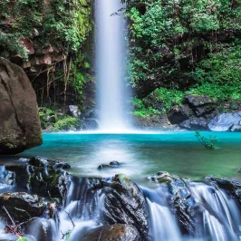 a large waterfall over a body of water