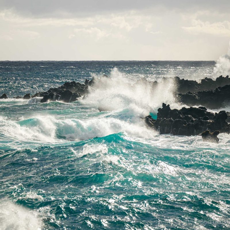 a man riding a wave on a surfboard in the ocean