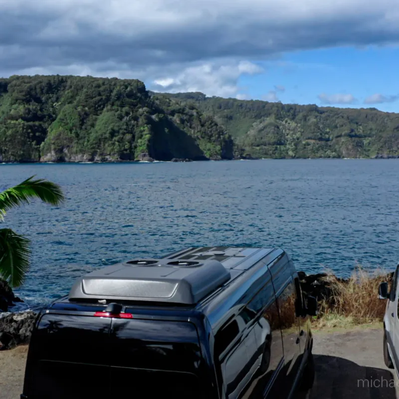 a car parked in front of a body of water
