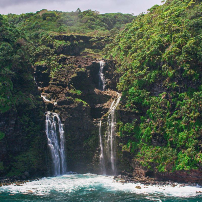 a large waterfall over a body of water