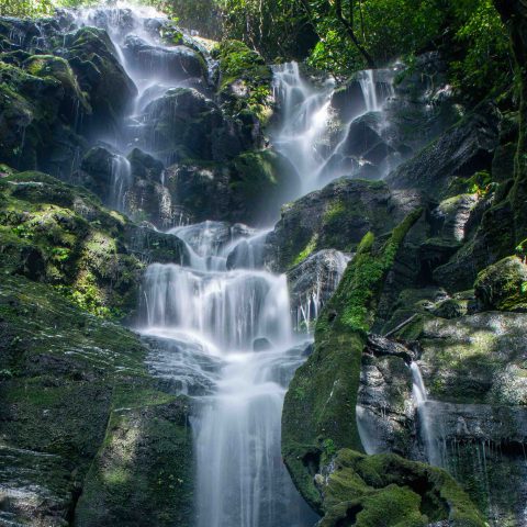a large waterfall over some water